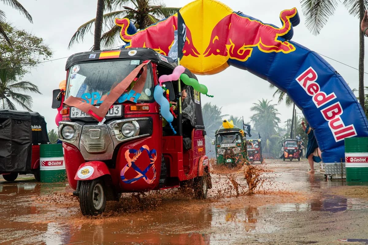 Tuktuk racing through rain at the Red Bull arch