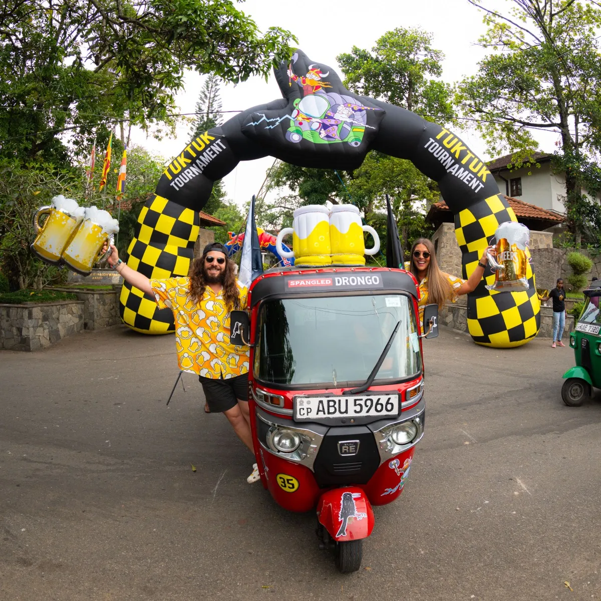 Team Drongo with giant beer mugs at the starting arch